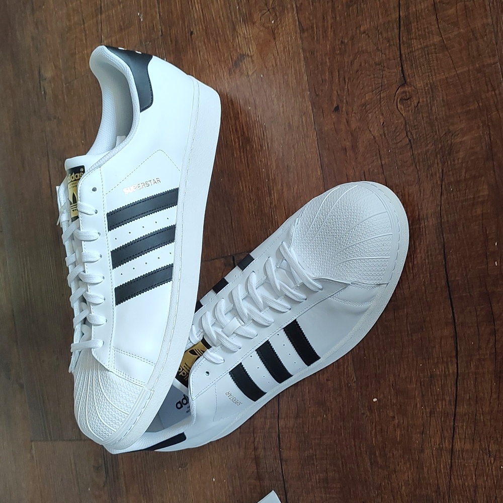 Adidas size 19 white leather shell toes shoes.